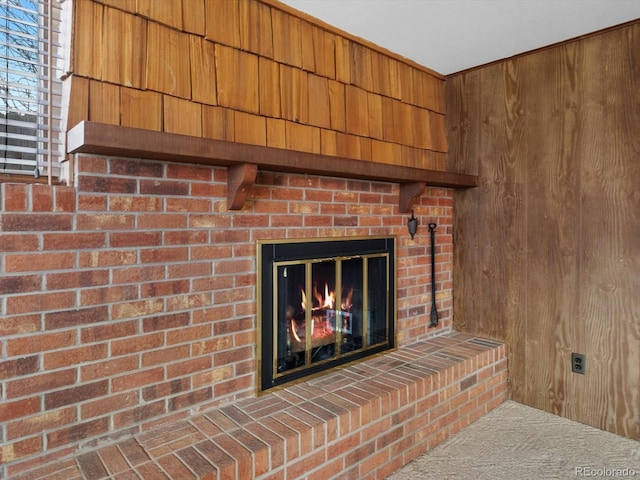 room details with wood walls and a fireplace