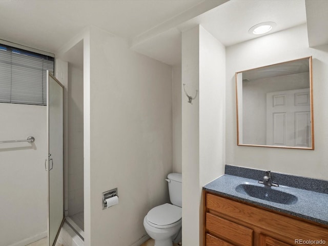 full bath featuring vanity, a shower stall, and toilet