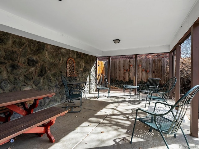 view of patio featuring fence