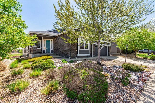 view of front facade with concrete driveway, brick siding, an attached garage, and covered porch