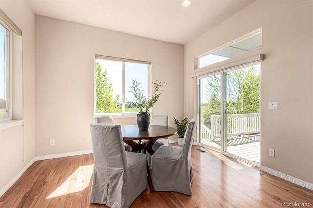 dining area featuring baseboards, recessed lighting, and wood finished floors