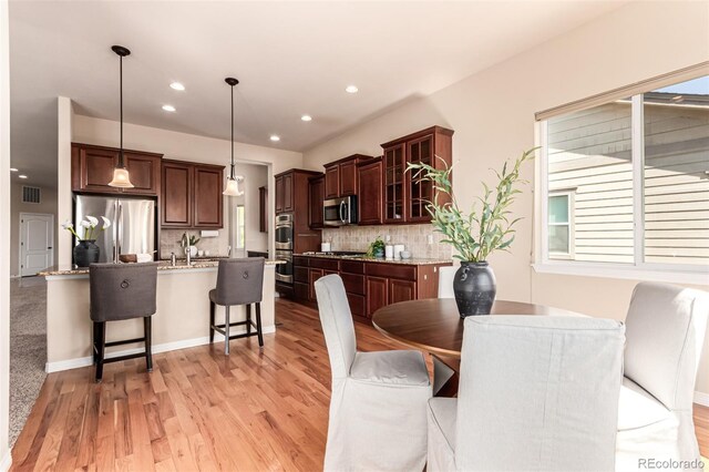 dining space with recessed lighting, light wood-style flooring, and visible vents
