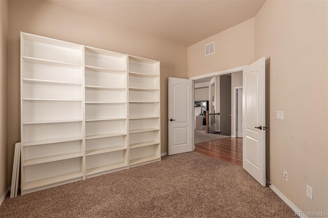 unfurnished bedroom featuring carpet flooring, baseboards, and visible vents