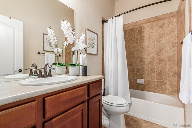 full bathroom with toilet, shower / bath combo with shower curtain, tile patterned flooring, and vanity