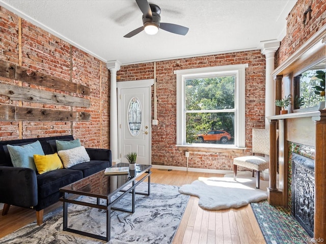 living room with wood-type flooring and brick wall