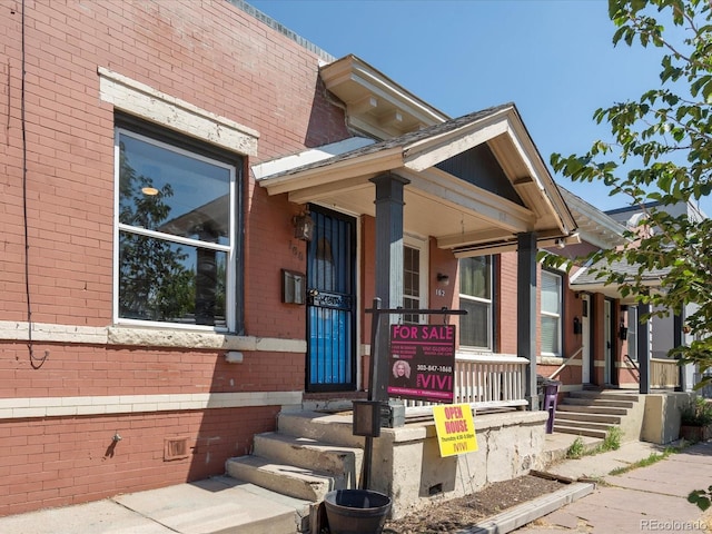 view of front facade with brick siding and crawl space