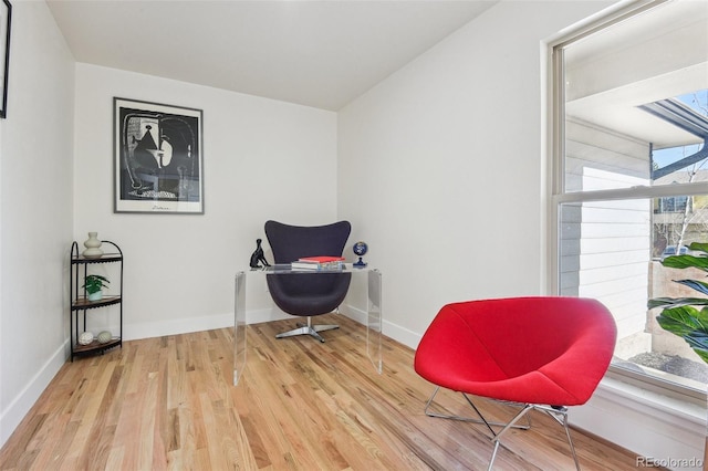 sitting room featuring baseboards and wood finished floors