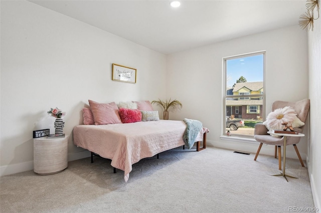 carpeted bedroom featuring visible vents and baseboards