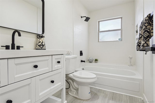 bathroom with toilet, bathing tub / shower combination, and vanity
