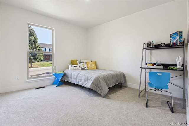 bedroom with carpet, visible vents, and baseboards