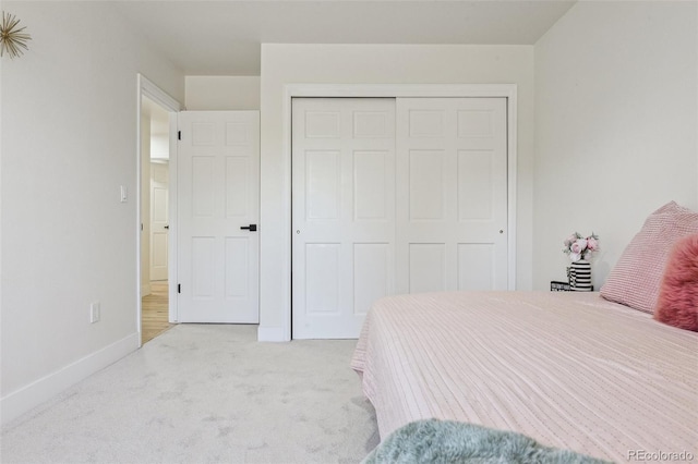 bedroom featuring a closet, baseboards, and carpet floors