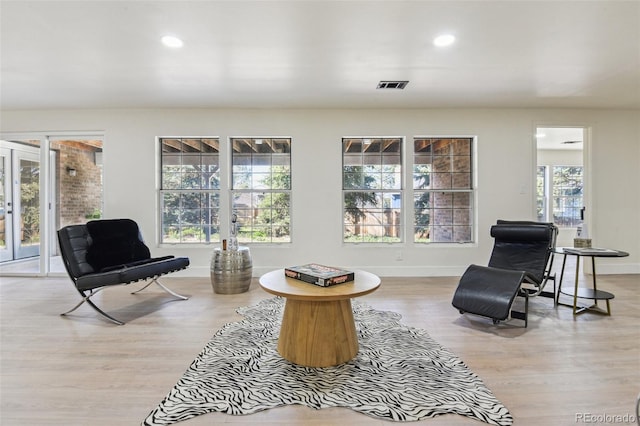 living area featuring wood finished floors, baseboards, visible vents, and recessed lighting