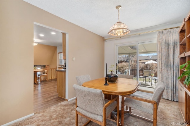 carpeted dining space featuring a textured ceiling