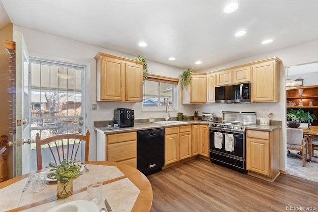 kitchen with range with electric stovetop, light brown cabinetry, black dishwasher, sink, and hardwood / wood-style flooring