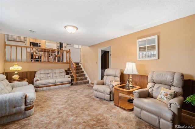 living room with light colored carpet and a textured ceiling