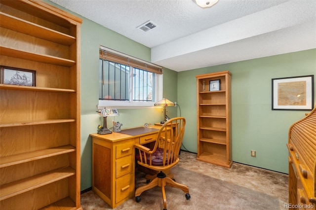 office space with light carpet and a textured ceiling