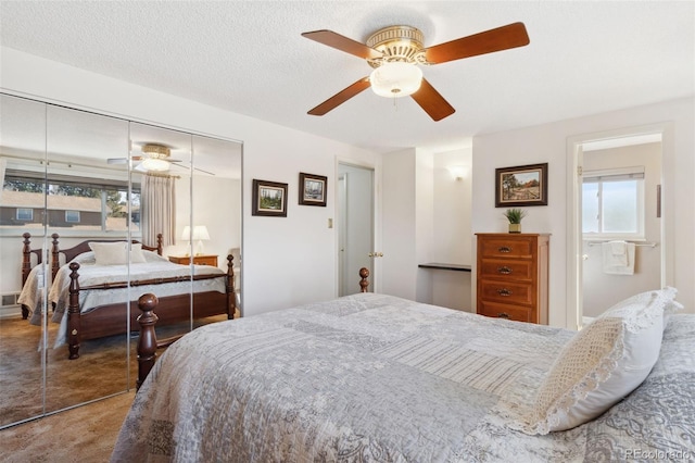 bedroom with a textured ceiling, ceiling fan, and a closet