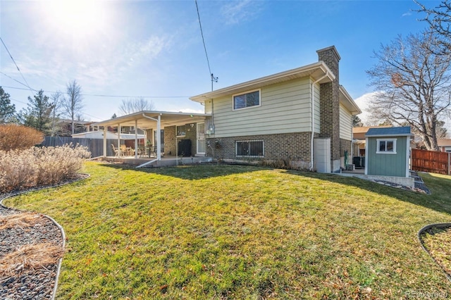 back of property with a storage unit and a lawn