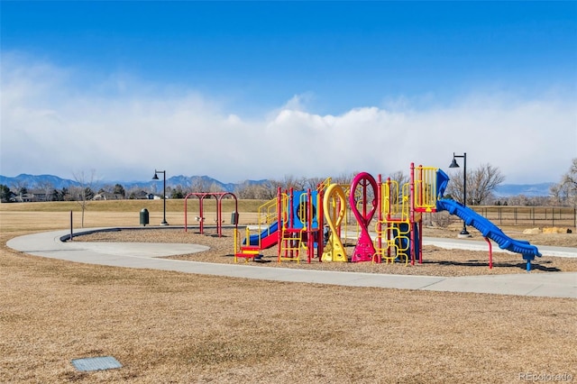 view of jungle gym with a mountain view