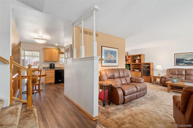 living room featuring dark hardwood / wood-style floors and a textured ceiling