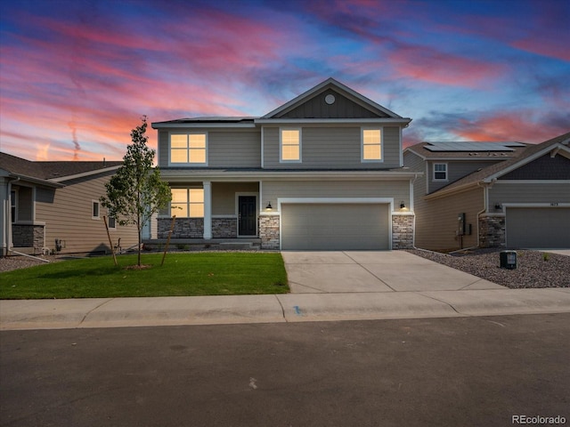 view of front facade featuring a lawn and a garage