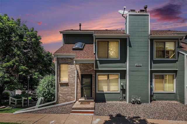 8753 W Cornell Ave Unit 12-1, Denver, CO 80227 - view of front of home with a chimney and roof with shingles