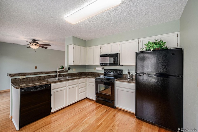 8753 W Cornell Ave Unit 12-1, Denver, CO 80227 - kitchen with black appliances, a textured ceiling, dark countertops, white cabinets, and light wood-style flooring