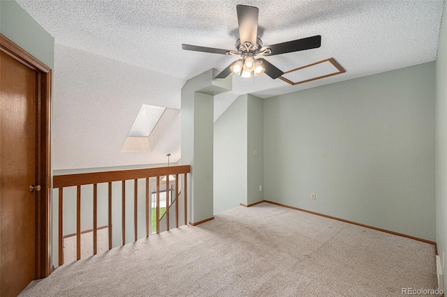 8753 W Cornell Ave Unit 12-1, Denver, CO 80227 - empty room featuring a skylight, a ceiling fan, carpet, and a textured ceiling