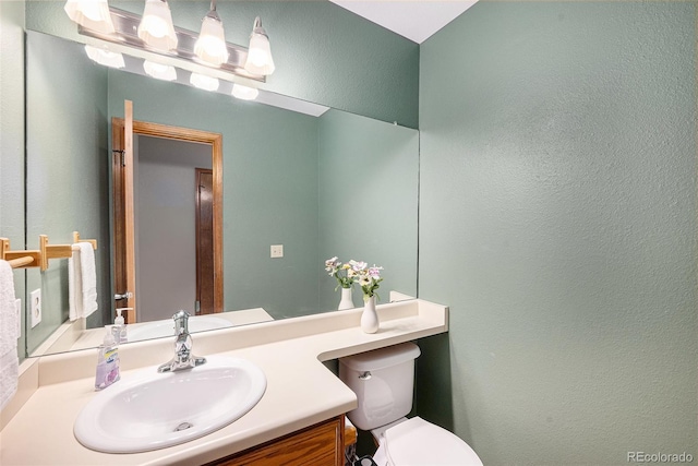 8753 W Cornell Ave Unit 12-1, Denver, CO 80227 - half bathroom featuring vanity and a textured wall