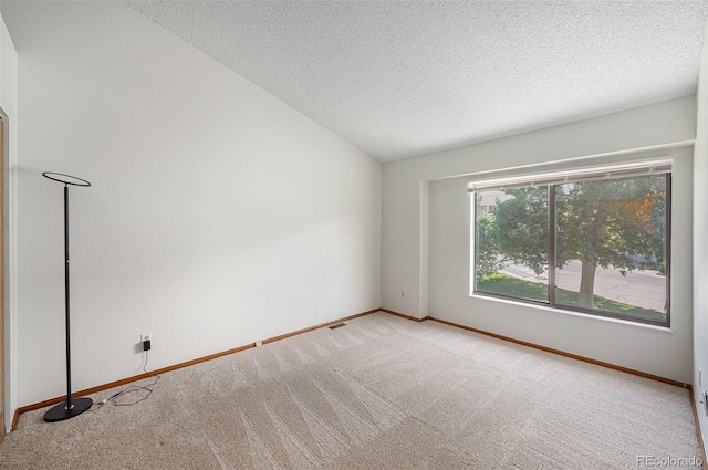 8753 W Cornell Ave Unit 12-1, Denver, CO 80227 - carpeted spare room featuring a textured ceiling and vaulted ceiling