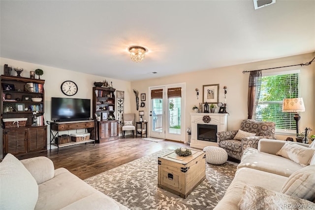 5843 Ceylon St, Denver, CO 80249 - living room with plenty of natural light, wood finished floors, and a glass covered fireplace