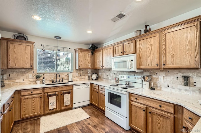5843 Ceylon St, Denver, CO 80249 - kitchen with white appliances, a sink, tasteful backsplash, dark wood-style floors, and recessed lighting
