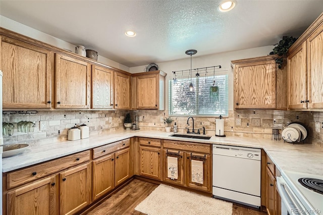 5843 Ceylon St, Denver, CO 80249 - kitchen with white appliances, a sink, tasteful backsplash, a textured ceiling, and recessed lighting
