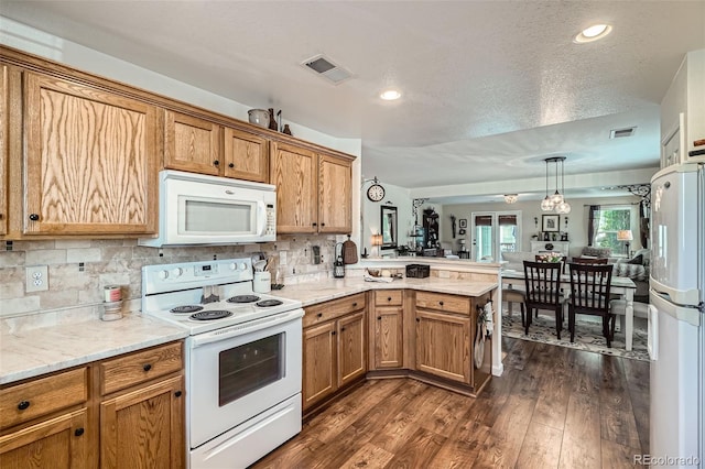 5843 Ceylon St, Denver, CO 80249 - kitchen featuring white appliances, a peninsula, decorative backsplash, dark wood finished floors, and a textured ceiling