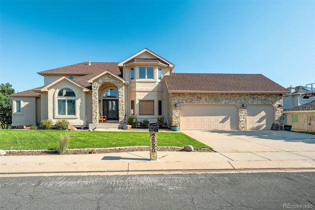 view of front of home with a front lawn and a garage