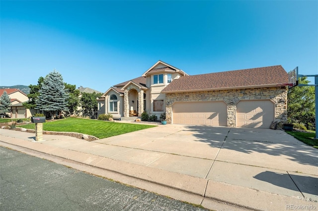 view of front of property featuring a garage and a front lawn