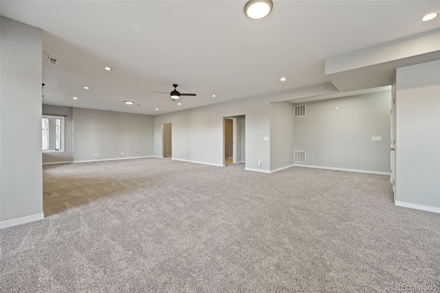 carpeted spare room with ceiling fan