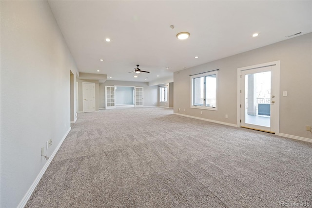 unfurnished living room featuring ceiling fan and light colored carpet