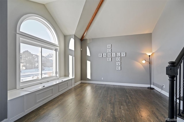 unfurnished living room featuring dark hardwood / wood-style flooring, vaulted ceiling, and plenty of natural light