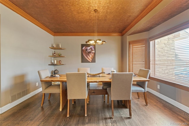 dining space with a wealth of natural light, wood-type flooring, ornamental molding, and an inviting chandelier