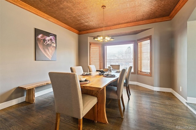 dining room with dark wood-type flooring, ornamental molding, and a notable chandelier