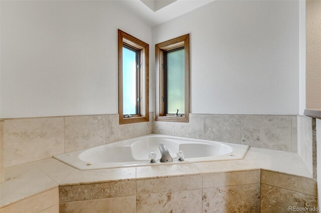 bathroom with tiled tub