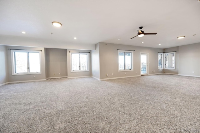 carpeted spare room with ceiling fan