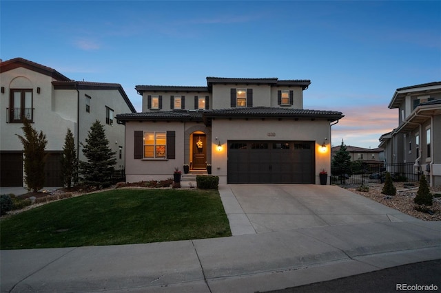 view of front of house with concrete driveway, fence, a tiled roof, and a front yard