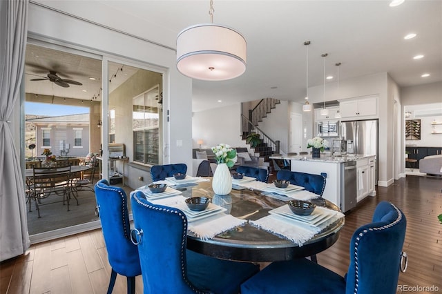dining space featuring stairway, a ceiling fan, wood finished floors, and recessed lighting