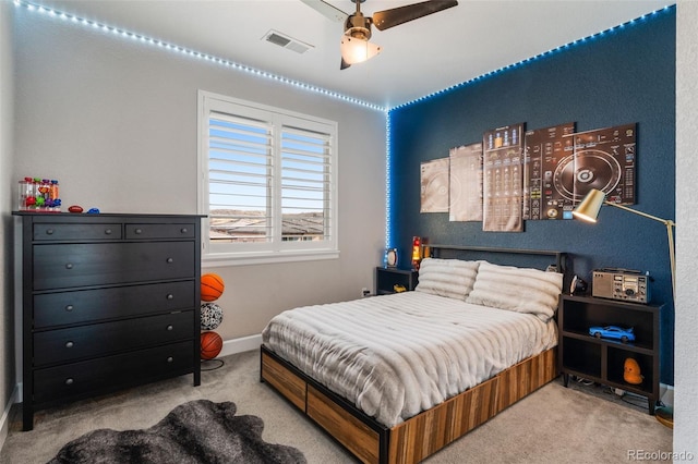 carpeted bedroom featuring ceiling fan, baseboards, and visible vents