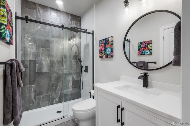 bathroom with a shower stall, marble finish floor, toilet, and vanity