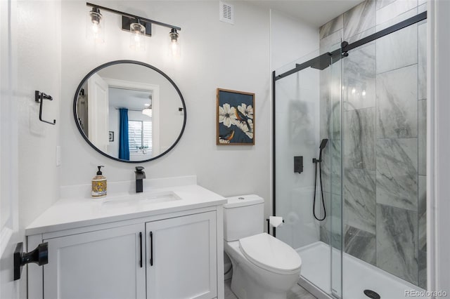 bathroom featuring a shower stall, visible vents, toilet, and vanity