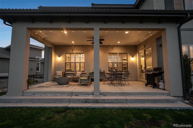 view of patio with an outdoor living space, a ceiling fan, and a grill