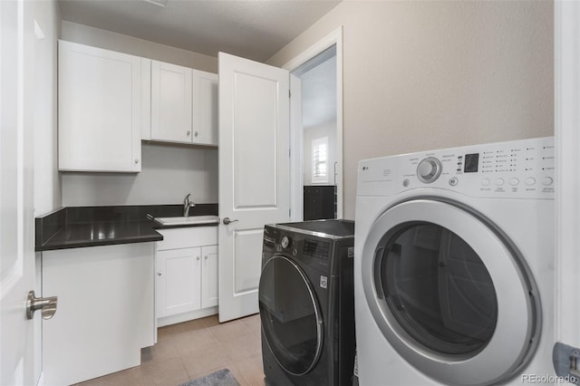 9724 Cantabria Pt, Lone Tree, CO 80124 - laundry room featuring washing machine and dryer, cabinet space, and light tile patterned floors